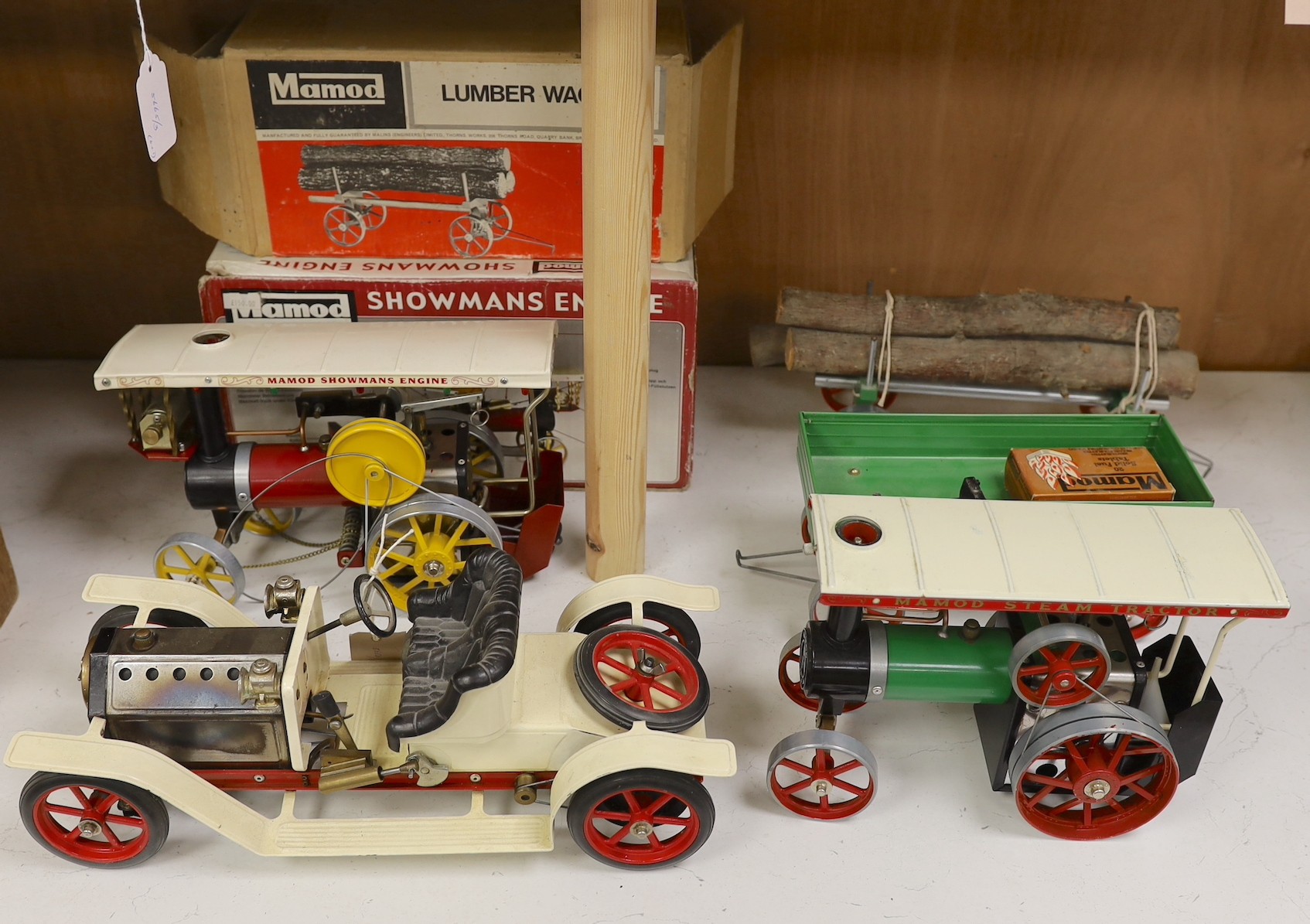 A boxed Mamod Showman's Engine and Lumbar wagon, and unboxed Steam Tractor and roadster- roadster 39 cms wide.